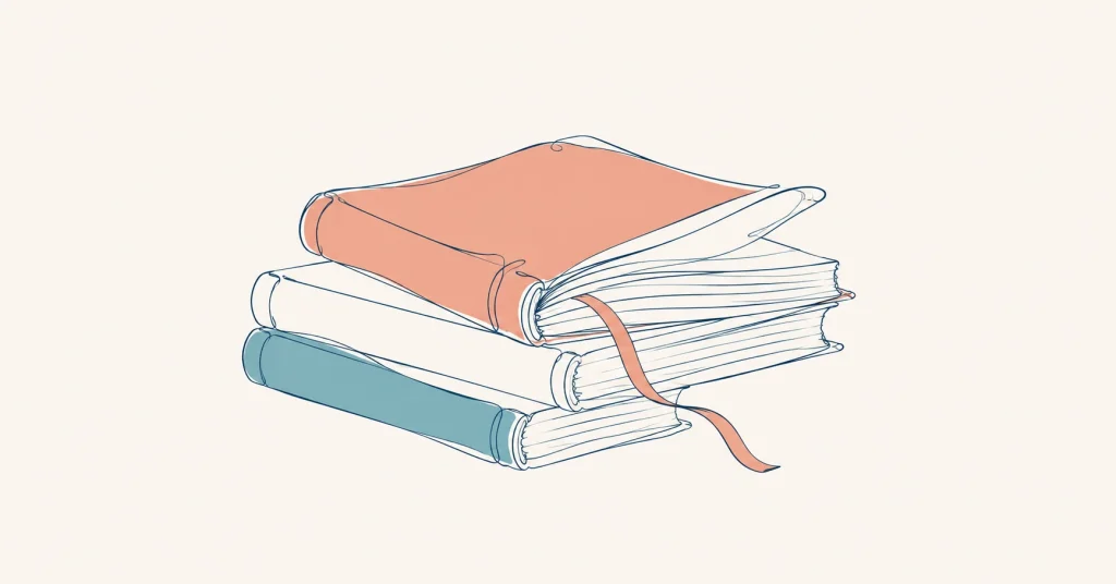 Stack of books with a well-loved coral book and a bookmark on top.